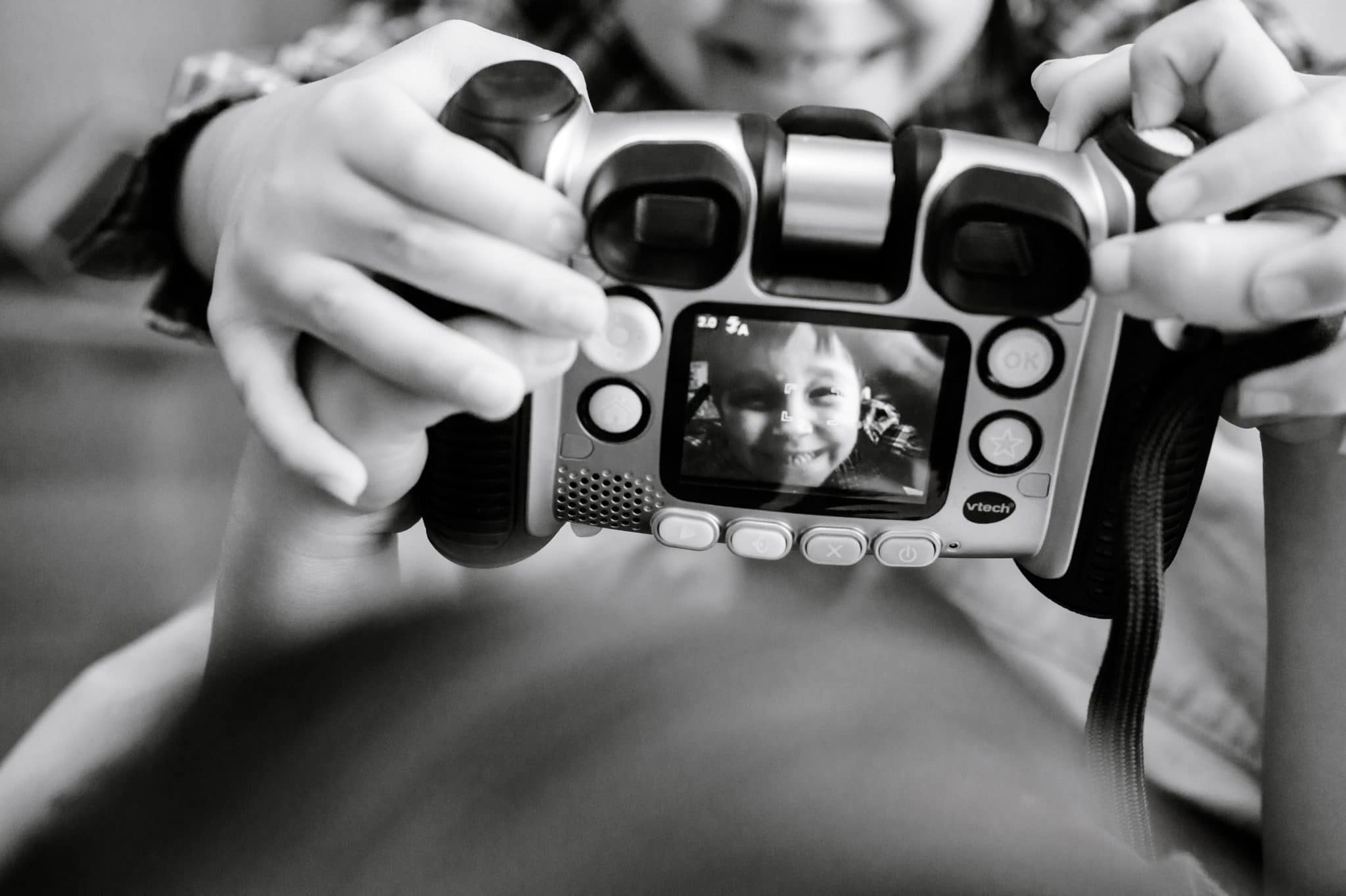 boys play with camera designed for kids