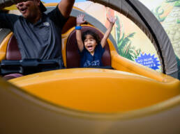 boy puts hands up on Slinky Dog