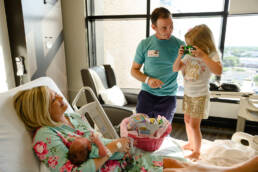 big sister meets brother at the hospital and takes a picture