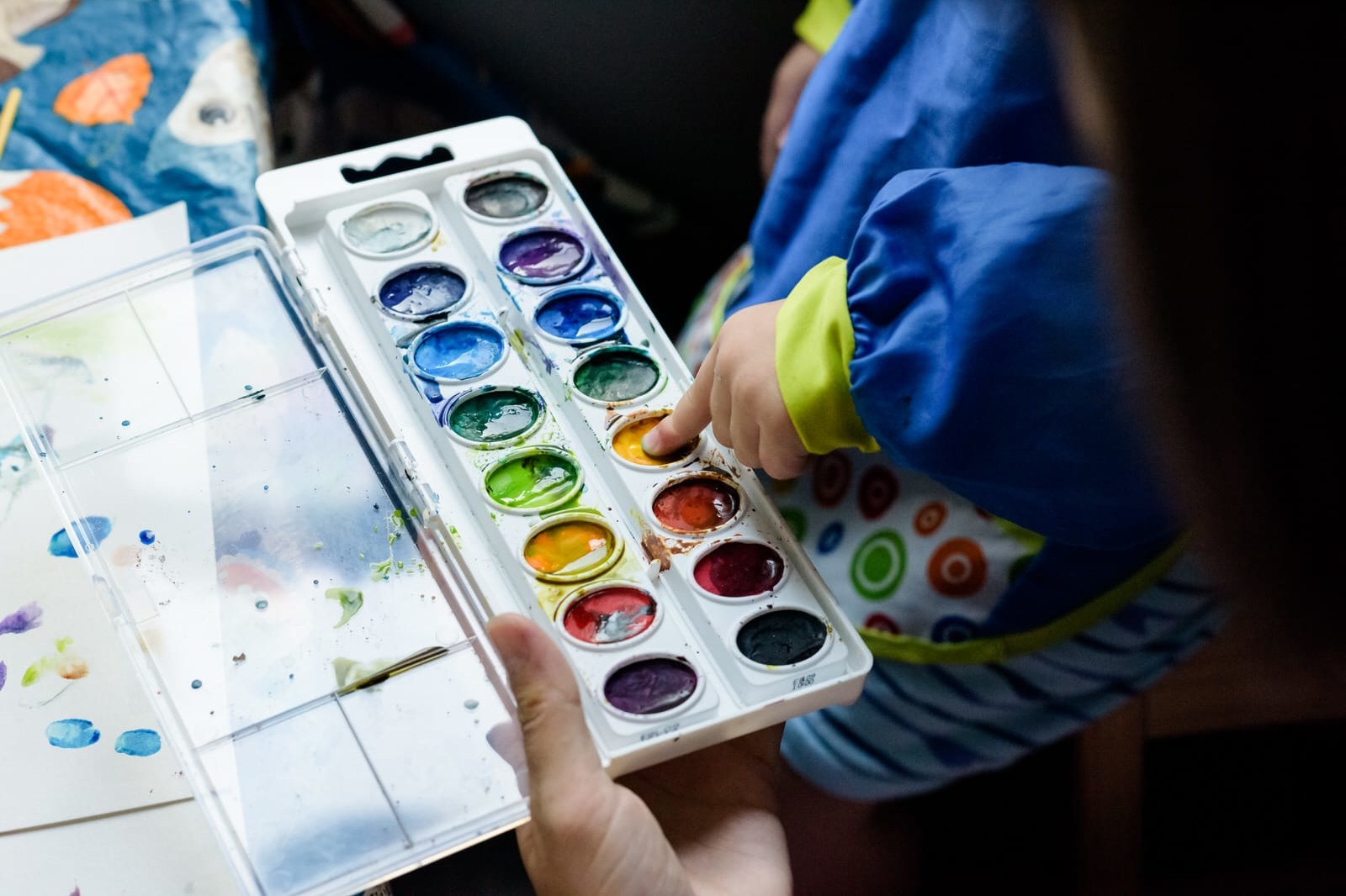 boy paints with fingers