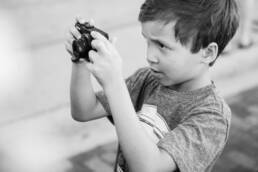 boy struggles to take a picture