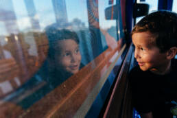 boy looks out window of Disney Skyliner