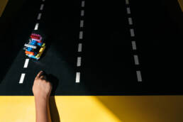 boy launches car at Lego Store
